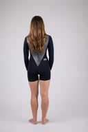 A woman wearing the Atmosea Mars spring suit against a white background, posing from the back. 