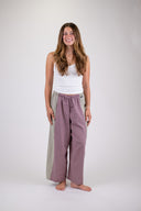 A woman wearing the Atmosea Patchwork pants against a white background, posing from the front.