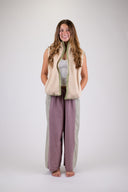 A woman wearing the Atmosea Surf Coach Vest against a white background, posing to the front. 