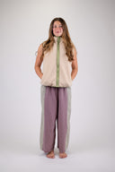 A woman wearing the Atmosea Surf Coach Vest against a white background, posing to the front. 