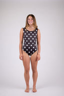 A woman wearing the Our Ripples Kiki suit against a white background, posing forward. 