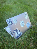 A photo of the spring tides sticker pack on a laptop