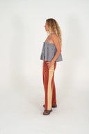 Atmosea Après Surf Panel Pants in rust brown cotton terry with cream side panels, a relaxed wide-leg silhouette, and adjustable drawstring waist.
