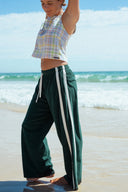 Atmosea Après Surf Pants in forest green cotton terry towelling with a relaxed wide-leg fit, elastic drawstring waist, and sporty canvas side stripes.