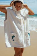 Atmosea Delfi Après Surf Robe made from plush cotton terry towelling with a zip front, oversized hood, front pockets, and dolphin embroidery.