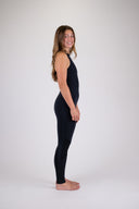 A woman wearing the Atmosea long jane wetsuit in black against a white background, posing to the side. 