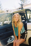 A model outside wearing the Atmosea Terry Towelling Après Surf Shorts in chocolate brown cotton terry with an elastic drawstring waistband and sporty side stripes.