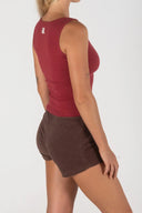 Profile view of the Inner Relm Checkers Top paired with brown shorts.