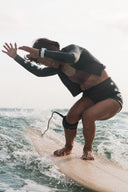 Surfer wearing the Inner Relm Green Envy Shorts 2mm during a surf session.