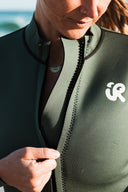 Close-up of the Inner Relm Green Envy Vest 2mm front zipper and logo.