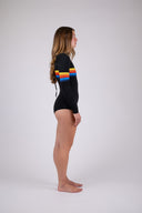 Woman wearing the Janga Black + Sunrise springsuit, side studio view