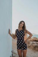 Model wearing the Our Ripples Canda Surfsuit 0.8mm in black with a white floral print.
