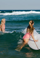 A model outside wearing the Salt Gypsy Everyday One Piece in Chilli Checkers