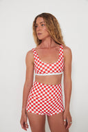 A model wearing the Salt Gypsy Original Betty Bottoms in Chilli Checkers red and cream checker print