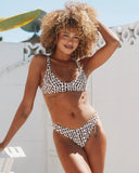 Lifestyle photo of the Seea Bobby Bikini Top in Curly Currents worn at the beach.