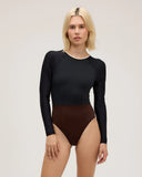 Front view of model wearing Seea Madi Surf Suit in Black/Cappuccino