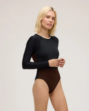 Front view of a model wearing Seea Madi Surf Suit in Black/Cappuccino in a studio