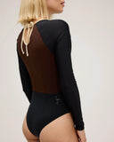 Up close view of side of model wearing Seea Madi Surf Suit in Black/Cappuccino