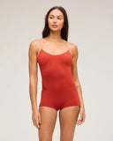 A model wearing the Seea Rosita One Piece women's surf suit in Cinnamon and posing to the front against a white background