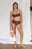 Model wearing Island Bikini Bottom in Cold Brew with fins in her hand