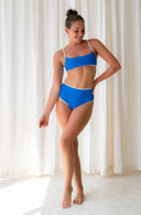 Front view of model wearing Island Bikini Bottom in Nineties Blue in a studio