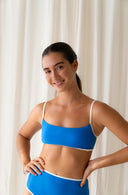 Up close view of model wearing Island Bikini Bottom in Nineties Blue in a studio