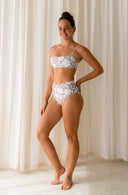 Side view of of model wearing Lucky Bikini Bottom in Aloha Dune Print in a studio