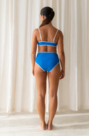 Back view of model wearing River Nineties Blue Bikini Top