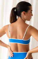 Back view of model wearing River Nineties Blue Bikini Top