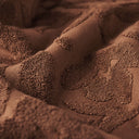Close-up of the raised sculpted floral texture on the Slowtide Sunny Sculpted Towel.