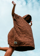 Back view of the Sunward Bound Hooded Changing Towel in Cacao showing the relaxed oversized silhouette and hood.