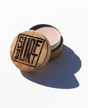 SurfDurt Tinted SPF 30 Mineral Sunscreen in a reusable bamboo container.